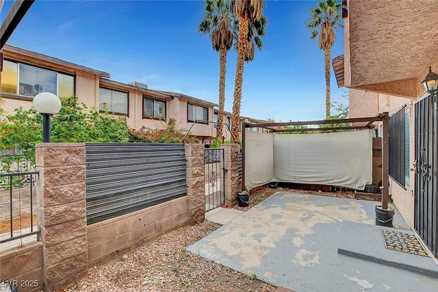 4339 Spencer St Unit 15, Las Vegas, NV 89119 - gate featuring fence and a patio