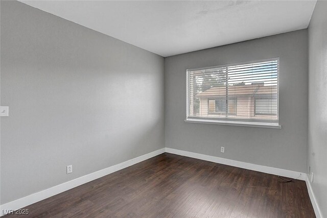 4339 Spencer St Unit 15, Las Vegas, NV 89119 - spare room with dark wood-style floors and baseboards