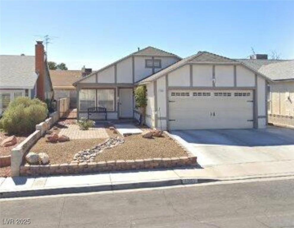 6365 Copperfield Ave, Las Vegas, NV 89108 - english style home featuring a garage and concrete driveway