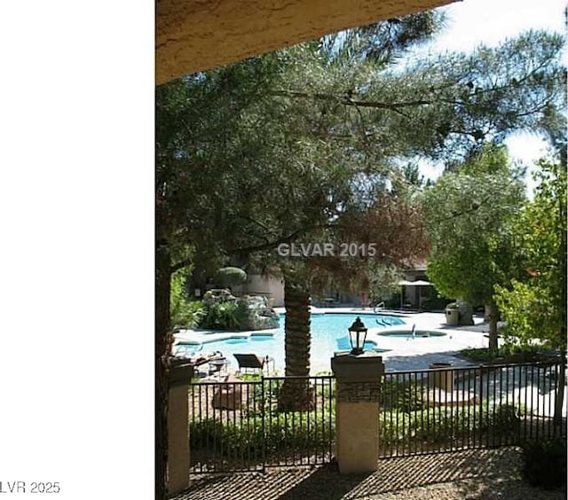 community pool featuring a patio area and fence