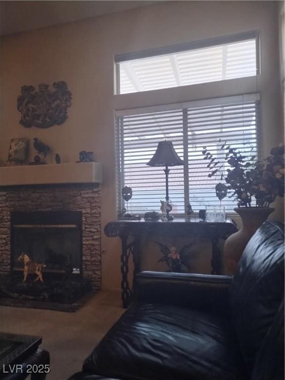 living area featuring plenty of natural light, a fireplace, and wood finished floors