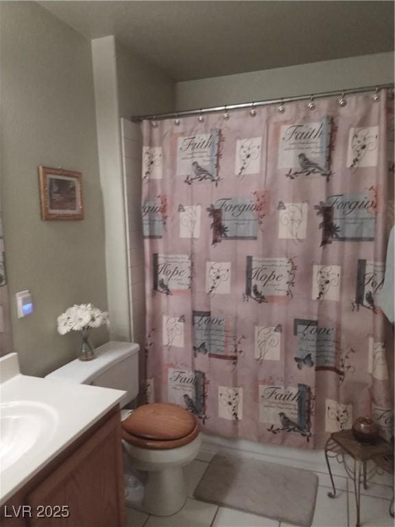 bathroom with tile patterned floors, vanity, toilet, and curtained shower