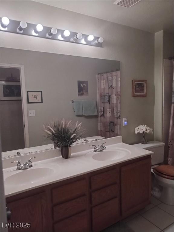 7894 W Patrick Ln, Las Vegas, NV 89113 - bathroom featuring tile patterned floors, toilet, and double vanity