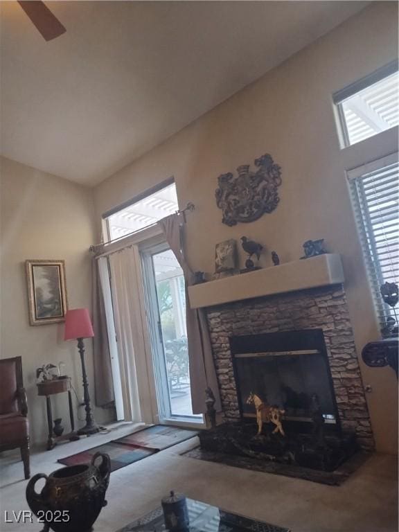 living room with plenty of natural light and a fireplace