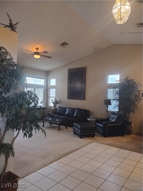 7894 W Patrick Ln, Las Vegas, NV 89113 - living room featuring light colored carpet, healthy amount of natural light, vaulted ceiling, and a ceiling fan