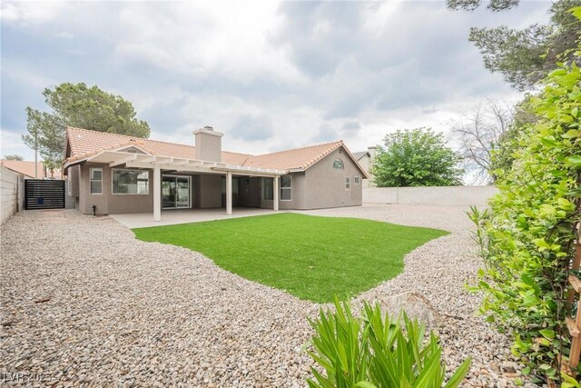 rear view of property with a tiled roof, a pergola, stucco siding, and a patio