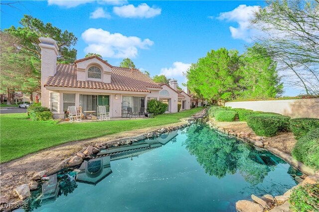 6940 Emerald Springs Ln, Las Vegas, NV 89113 - back of property with a yard, stucco siding, a tiled roof, a pool, and a chimney