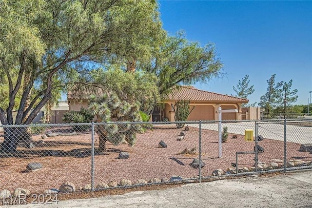 5202 Willis St, North Las Vegas, NV 89031 - view of front of property with an attached garage, driveway, fence, stucco siding, and a tile roof