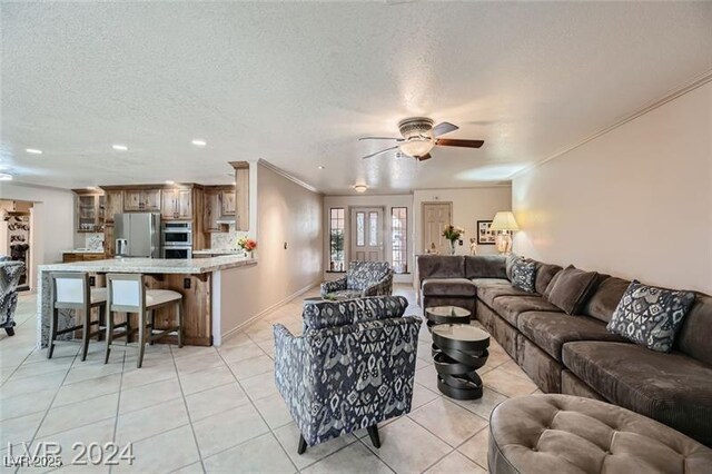 5202 Willis St, North Las Vegas, NV 89031 - living room featuring crown molding, light tile patterned flooring, a ceiling fan, recessed lighting, and a textured ceiling