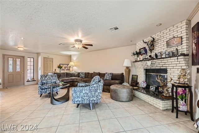 5202 Willis St, North Las Vegas, NV 89031 - tiled living room with ceiling fan, a textured ceiling, and a brick fireplace