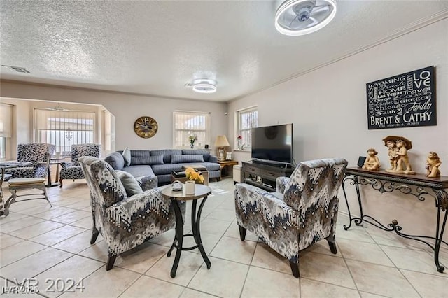 5202 Willis St, North Las Vegas, NV 89031 - living area featuring healthy amount of natural light, a textured ceiling, and light tile patterned floors