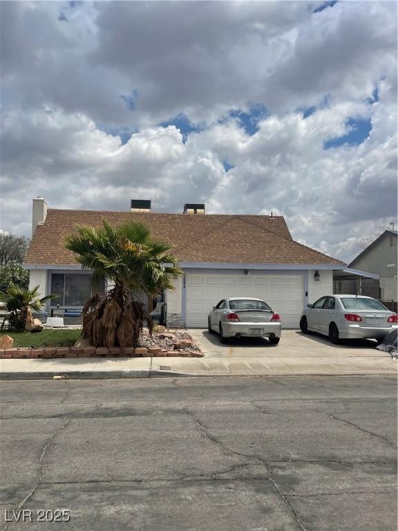 ranch-style home with a garage and concrete driveway