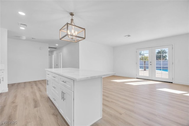 1616 Yellow Rose St, Las Vegas, NV 89108 - kitchen with light wood-type flooring, white cabinets, a center island, recessed lighting, and hanging light fixtures