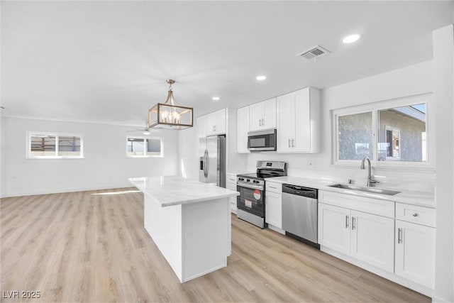 1616 Yellow Rose St, Las Vegas, NV 89108 - kitchen with stainless steel appliances, a sink, plenty of natural light, white cabinetry, and recessed lighting