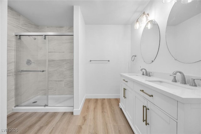 1616 Yellow Rose St, Las Vegas, NV 89108 - bathroom featuring wood finished floors, a shower stall, double vanity, and baseboards
