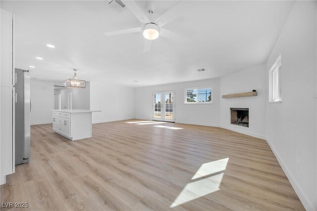 1616 Yellow Rose St, Las Vegas, NV 89108 - unfurnished living room featuring light wood finished floors, a fireplace, a ceiling fan, recessed lighting, and baseboards