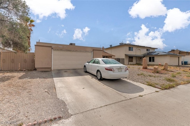 604 N Torrey Pines Dr, Las Vegas, NV 89107 - view of front of property with a garage, stucco siding, and fence