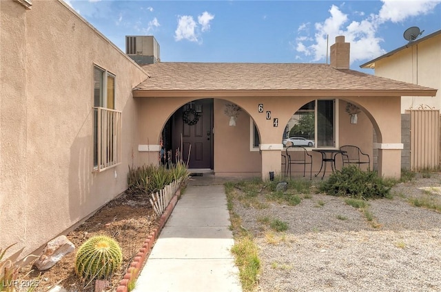 604 N Torrey Pines Dr, Las Vegas, NV 89107 - entrance to property with stucco siding, covered porch, and a chimney