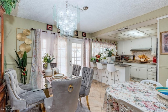 604 N Torrey Pines Dr, Las Vegas, NV 89107 - dining room with a chandelier, light tile patterned flooring, and a textured ceiling