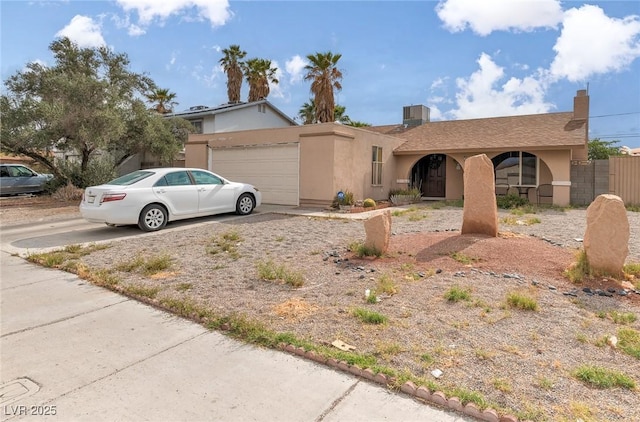 604 N Torrey Pines Dr, Las Vegas, NV 89107 - view of front facade featuring a garage, stucco siding, driveway, and fence