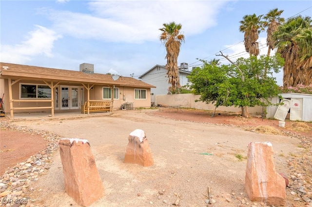 604 N Torrey Pines Dr, Las Vegas, NV 89107 - back of property with french doors and a fenced backyard