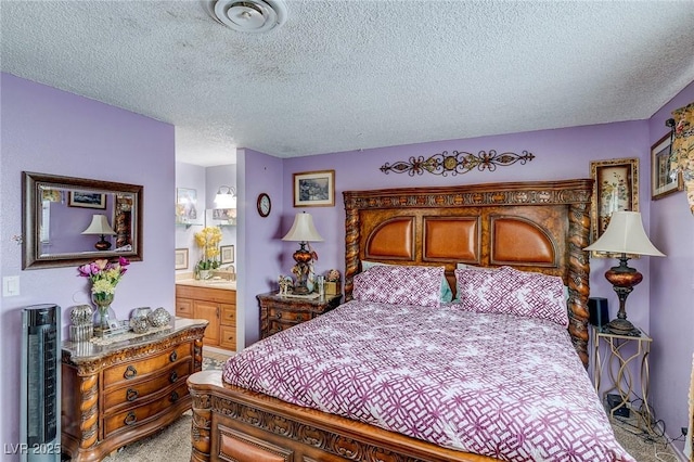 604 N Torrey Pines Dr, Las Vegas, NV 89107 - bedroom with a textured ceiling, connected bathroom, and light carpet