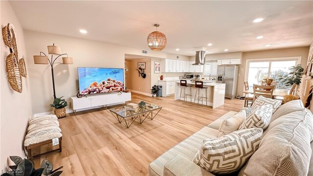 2043 Sombrero Dr, Las Vegas, NV 89169 - living room featuring recessed lighting, light wood-type flooring, baseboards, and a chandelier