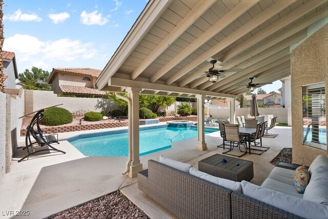 view of swimming pool with an outdoor living space, a fenced backyard, a patio, and ceiling fan