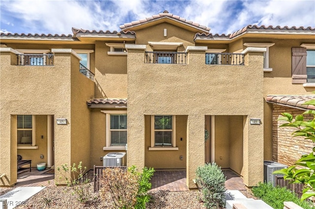49 Alamere Falls Dr, Las Vegas, NV 89138 - view of front facade with a tiled roof, central air condition unit, and stucco siding