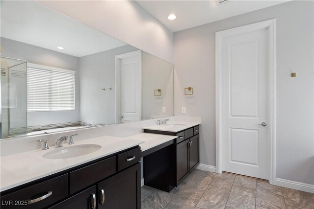 bathroom featuring baseboards and vanity