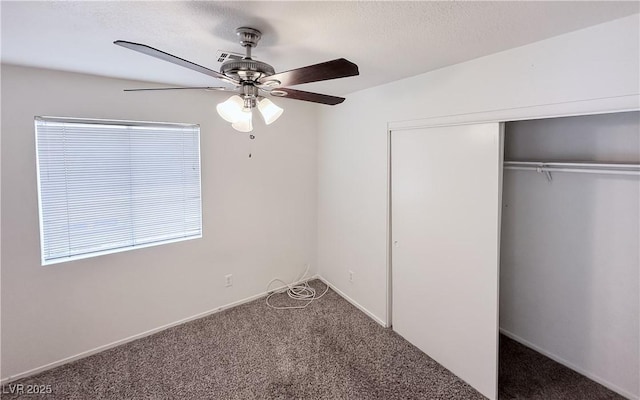 unfurnished bedroom featuring carpet floors, a closet, ceiling fan, and a textured ceiling