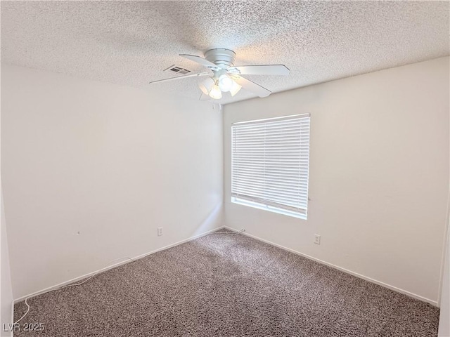 spare room featuring a ceiling fan, carpet flooring, baseboards, and a textured ceiling