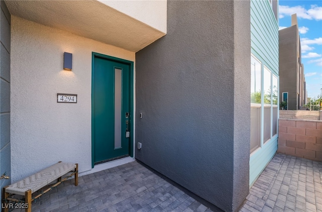 entrance to property with stucco siding