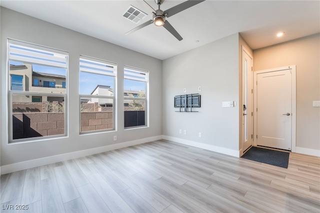 empty room with light wood finished floors, ceiling fan, baseboards, and recessed lighting