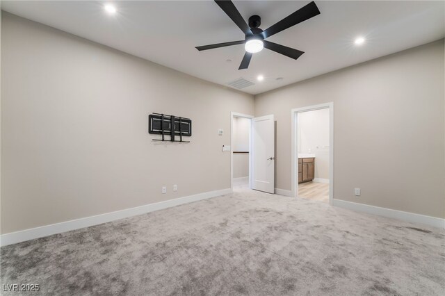 unfurnished bedroom with recessed lighting, light colored carpet, baseboards, ensuite bath, and a ceiling fan