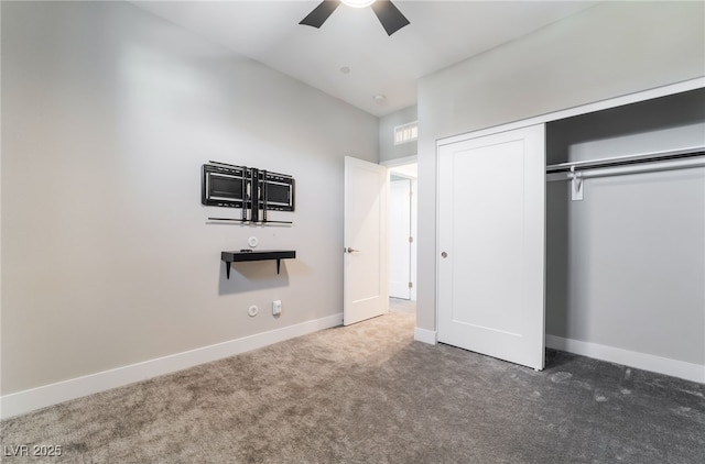 unfurnished bedroom with carpet, a closet, baseboards, a towering ceiling, and ceiling fan