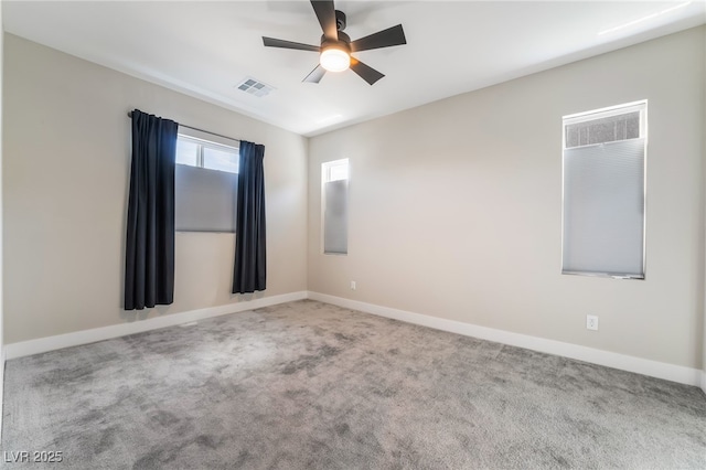 spare room featuring carpet, a ceiling fan, and baseboards