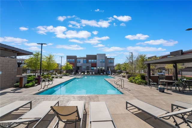 community pool featuring a patio and fence