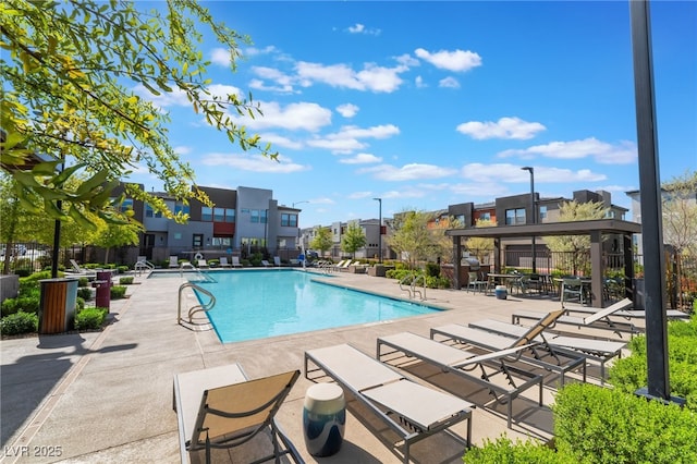 community pool featuring a patio and a residential view