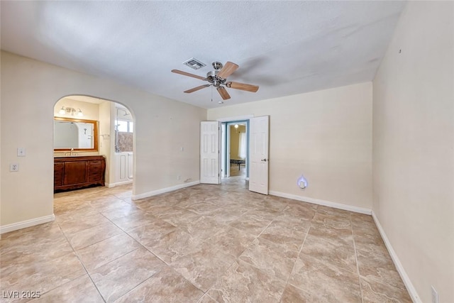 632 Arrayo Way, Boulder City, NV 89005 - empty room featuring ceiling fan, arched walkways, and baseboards