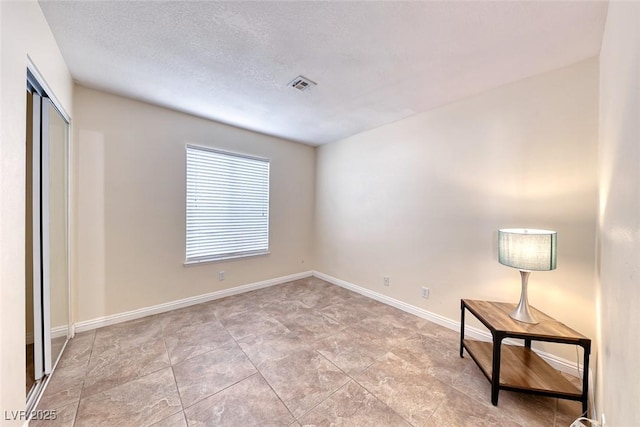 632 Arrayo Way, Boulder City, NV 89005 - unfurnished bedroom featuring baseboards, a closet, and a textured ceiling