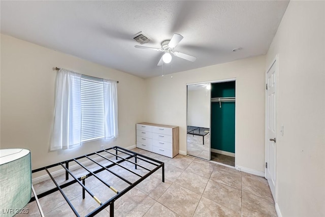 632 Arrayo Way, Boulder City, NV 89005 - unfurnished bedroom featuring a closet, baseboards, ceiling fan, a textured ceiling, and light tile patterned floors