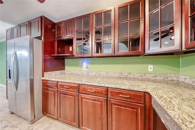 632 Arrayo Way, Boulder City, NV 89005 - kitchen featuring appliances with stainless steel finishes, light tile patterned flooring, glass insert cabinets, and light stone counters