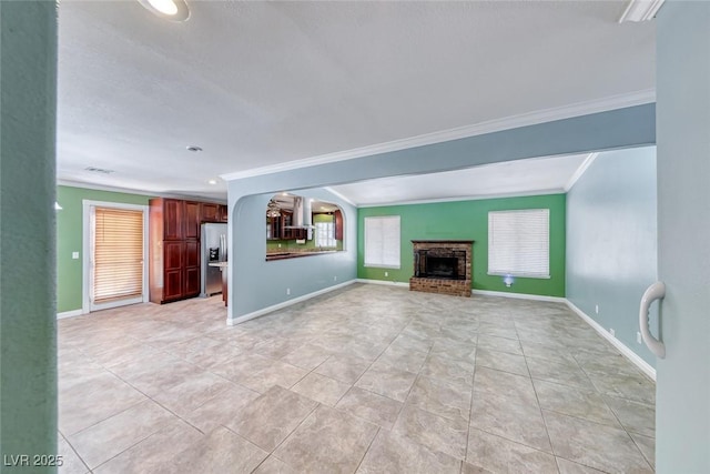 632 Arrayo Way, Boulder City, NV 89005 - unfurnished living room featuring crown molding, light tile patterned floors, a brick fireplace, baseboards, and arched walkways