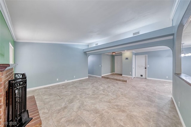 632 Arrayo Way, Boulder City, NV 89005 - unfurnished living room with arched walkways, ornamental molding, a brick fireplace, and baseboards