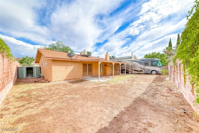 632 Arrayo Way, Boulder City, NV 89005 - back of house with a fenced backyard, stucco siding, a patio area, and a chimney