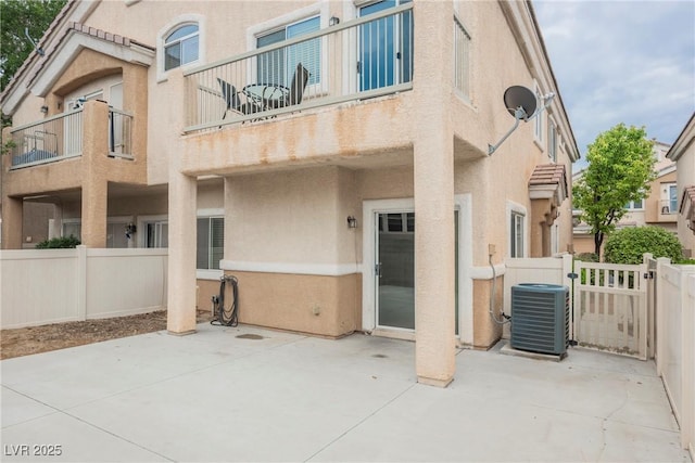 back of house featuring stucco siding, fence, and a patio area