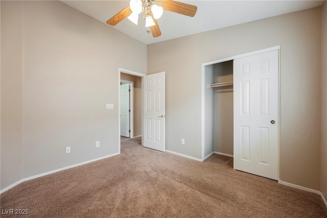 unfurnished bedroom with carpet floors, baseboards, a closet, a ceiling fan, and vaulted ceiling