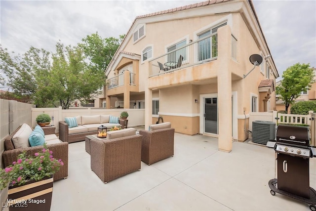 back of property featuring an outdoor living space, central AC unit, stucco siding, a fenced backyard, and a patio area