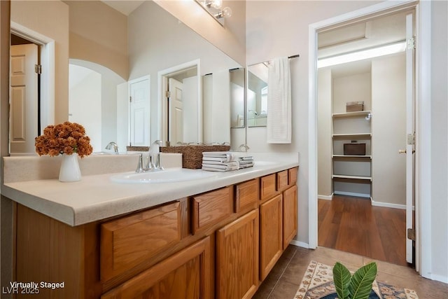 bathroom featuring vanity, tile patterned flooring, and baseboards